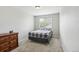 Neutral bedroom with plaid bedspread, carpet, and natural light at 1440 E 128Th Ct, Thornton, CO 80241