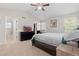 Spacious bedroom with high ceilings, large windows, TV, ceiling fan, and ensuite bathroom with shower at 1440 E 128Th Ct, Thornton, CO 80241