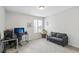 Neutral bedroom with gray sofa, home office setup, and natural light at 1440 E 128Th Ct, Thornton, CO 80241