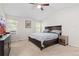 Inviting bedroom with plush carpet, a ceiling fan, and windows providing natural light, creating a comfortable atmosphere at 1440 E 128Th Ct, Thornton, CO 80241