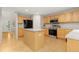Bright kitchen with stainless steel appliances, center island, and a view to the backyard at 1440 E 128Th Ct, Thornton, CO 80241