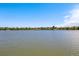 Scenic lake view with houses lining the shore, offering a tranquil and picturesque setting at 1440 E 128Th Ct, Thornton, CO 80241