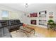 Cozy living room with a fireplace, built-in shelving, and a comfortable leather sofa at 1440 E 128Th Ct, Thornton, CO 80241