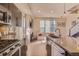 Open concept living space with a gas range, fireplace, and natural light from large windows at 2114 N Clay St, Denver, CO 80211