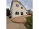 A patio in the backyard of a two-story home with a sliding glass door at 10064 Westside Cir, Littleton, CO 80125