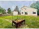A spacious backyard with shed, grass, mature trees and a raised garden at 10064 Westside Cir, Littleton, CO 80125