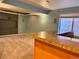 Finished basement featuring a bar area, neutral carpet, and natural light from a window at 10064 Westside Cir, Littleton, CO 80125