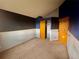 A carpeted bedroom featuring two closets and an accent wall at 10064 Westside Cir, Littleton, CO 80125