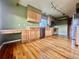 Kitchen with wood cabinets, tile countertops, and a built-in desk area at 10064 Westside Cir, Littleton, CO 80125