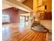 Spacious living room featuring hardwood floors, a staircase, and a sliding glass door at 10064 Westside Cir, Littleton, CO 80125