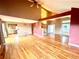 Open concept living room with hardwood floors connecting to kitchen and other rooms at 10064 Westside Cir, Littleton, CO 80125