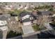 Overhead view of a two-story home with a two-car garage, a driveway, and mature trees at 2875 S Tower Way, Aurora, CO 80013
