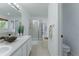 Modern bathroom with double sinks, a walk-in shower, and a bathtub at 2875 S Tower Way, Aurora, CO 80013