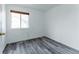 Spare bedroom featuring wood-look floors and a window offering ample natural light at 2875 S Tower Way, Aurora, CO 80013