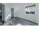Bedroom featuring wood-look floors, ample natural light, and a closet with sliding doors at 2875 S Tower Way, Aurora, CO 80013