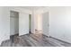 Empty bedroom featuring wood-look floors, closet with sliding doors, and ample natural light at 2875 S Tower Way, Aurora, CO 80013