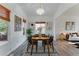 Bright dining room with a modern chandelier, wood floors, and a view into the living room at 2875 S Tower Way, Aurora, CO 80013