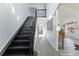 Bright entryway with staircase, tiled floors, and modern decor leading to other rooms at 2875 S Tower Way, Aurora, CO 80013