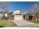 Charming two-story home featuring a two-car garage, well-maintained lawn, and mature trees at 2875 S Tower Way, Aurora, CO 80013