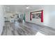 Open-concept living area with wood floors, and large windows at 2875 S Tower Way, Aurora, CO 80013