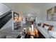 Open-concept living room leading into the dining area, featuring modern decor and wood floors at 2875 S Tower Way, Aurora, CO 80013