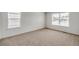 Bright bedroom with two windows and carpeted floor at 13547 Valentia St, Thornton, CO 80602