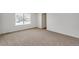 Bedroom with window, carpet and door to bathroom at 13547 Valentia St, Thornton, CO 80602