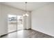 Bright dining room with hardwood floors and sliding glass door at 13547 Valentia St, Thornton, CO 80602