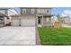 Two-story house with neutral siding, two-car garage, and a landscaped lawn at 13547 Valentia St, Thornton, CO 80602