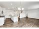 Modern kitchen with island, white cabinets, and stainless steel appliances at 13547 Valentia St, Thornton, CO 80602