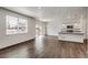 Open concept kitchen with island and hardwood floors at 13547 Valentia St, Thornton, CO 80602