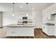Modern kitchen with white cabinets and granite countertops at 13547 Valentia St, Thornton, CO 80602