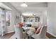 Open concept dining room with built-in shelving and view into living room at 9671 Fox Den Dr, Littleton, CO 80125