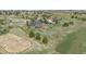 Aerial view of blue house with large lot, open space, and horse property nearby at 21166 E Euclid Dr, Centennial, CO 80016