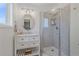 Bright bathroom featuring a glass enclosed shower, floating shelves, and a modern vanity at 21166 E Euclid Dr, Centennial, CO 80016