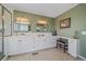 Bathroom with double vanity and tile floors, including a seating vanity at 21166 E Euclid Dr, Centennial, CO 80016