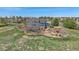 A beautiful two-story home with a large yard and mature trees on a sunny day at 21166 E Euclid Dr, Centennial, CO 80016