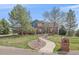 Charming two-story home with a brick facade, lush lawn, mature trees, and a curved walkway to the front door at 21166 E Euclid Dr, Centennial, CO 80016