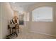 Hallway featuring archway to the left and view of the Living area, wood table and accent piece at 21166 E Euclid Dr, Centennial, CO 80016