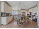 Modern kitchen with white cabinets, granite countertops, stainless steel appliances, and a functional center island at 21166 E Euclid Dr, Centennial, CO 80016