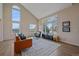 Open-concept living room featuring vaulted ceilings, large windows, an area rug, and views to the outside at 21166 E Euclid Dr, Centennial, CO 80016