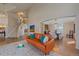 Spacious open-concept living room with hardwood floors, leather sofa, stairway and view into the dining area at 21166 E Euclid Dr, Centennial, CO 80016