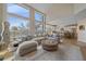 Spacious living room featuring large windows, a comfortable sectional sofa, and an open layout to the kitchen at 21166 E Euclid Dr, Centennial, CO 80016