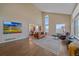 Bright living room featuring soaring ceilings, hardwood floors, an area rug, and ample seating at 21166 E Euclid Dr, Centennial, CO 80016