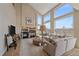 Bright and airy living room with tall ceilings, fireplace, hardwood floors, an area rug, and oversized windows at 21166 E Euclid Dr, Centennial, CO 80016