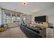 Bright living room with a large window offering scenic backyard views and a large entertainment center at 21166 E Euclid Dr, Centennial, CO 80016