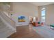 Spacious living room with soaring ceilings, large windows, hardwood floors, and a leather sofa at 21166 E Euclid Dr, Centennial, CO 80016
