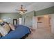 Bedroom with a ceiling fan, a large window, and an open entrance to a hallway at 21166 E Euclid Dr, Centennial, CO 80016
