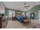 Spacious main bedroom with tray ceiling, large windows, dresser, and decorative rug at 21166 E Euclid Dr, Centennial, CO 80016