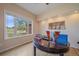 Bright office space with a large window, hardwood floors, and a charming desk, creating a productive work environment at 21166 E Euclid Dr, Centennial, CO 80016